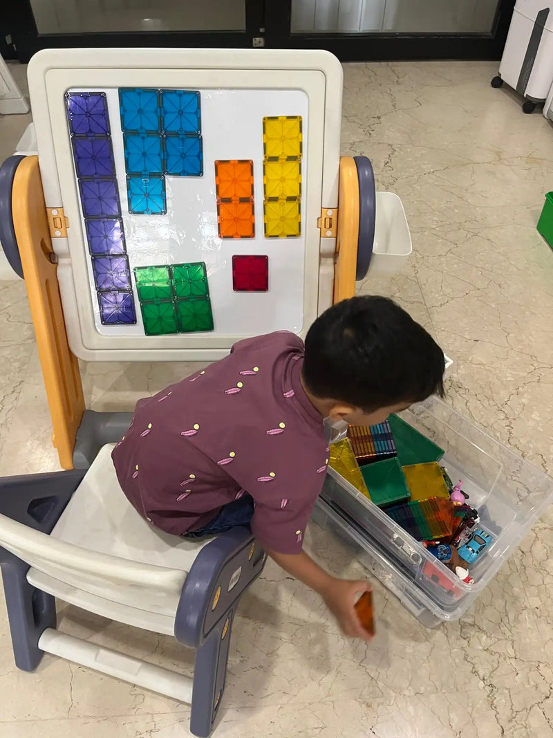 A child’s magnetic tile building set with an easel and storage bin.