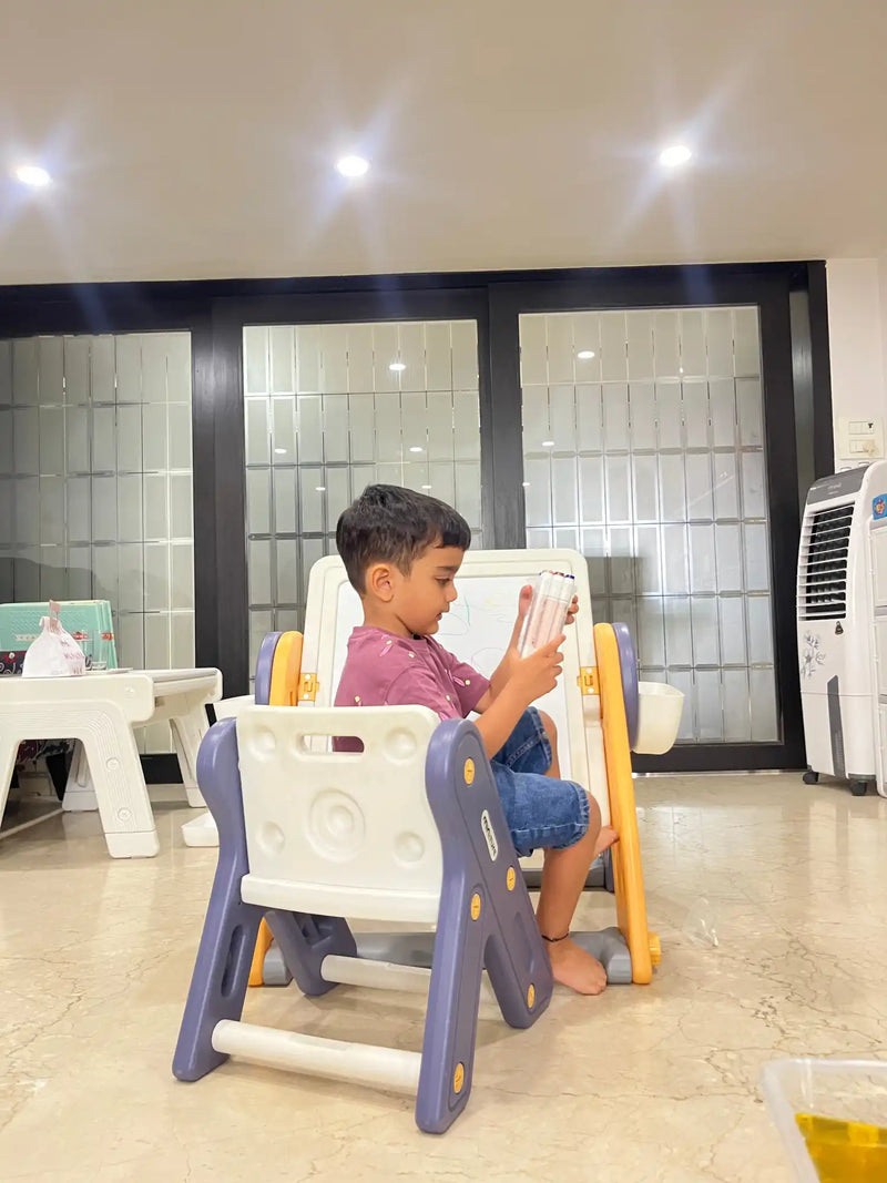 A child’s two-sided easel with a chair, featuring a whiteboard and a blackboard.