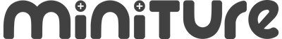 A low-resolution, pixelated digital image with a dark gray background and black shapes, including two white plus signs.