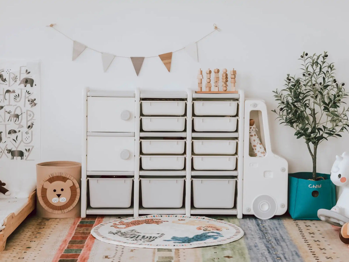 White modular toy storage unit with bins and a truck-shaped side.