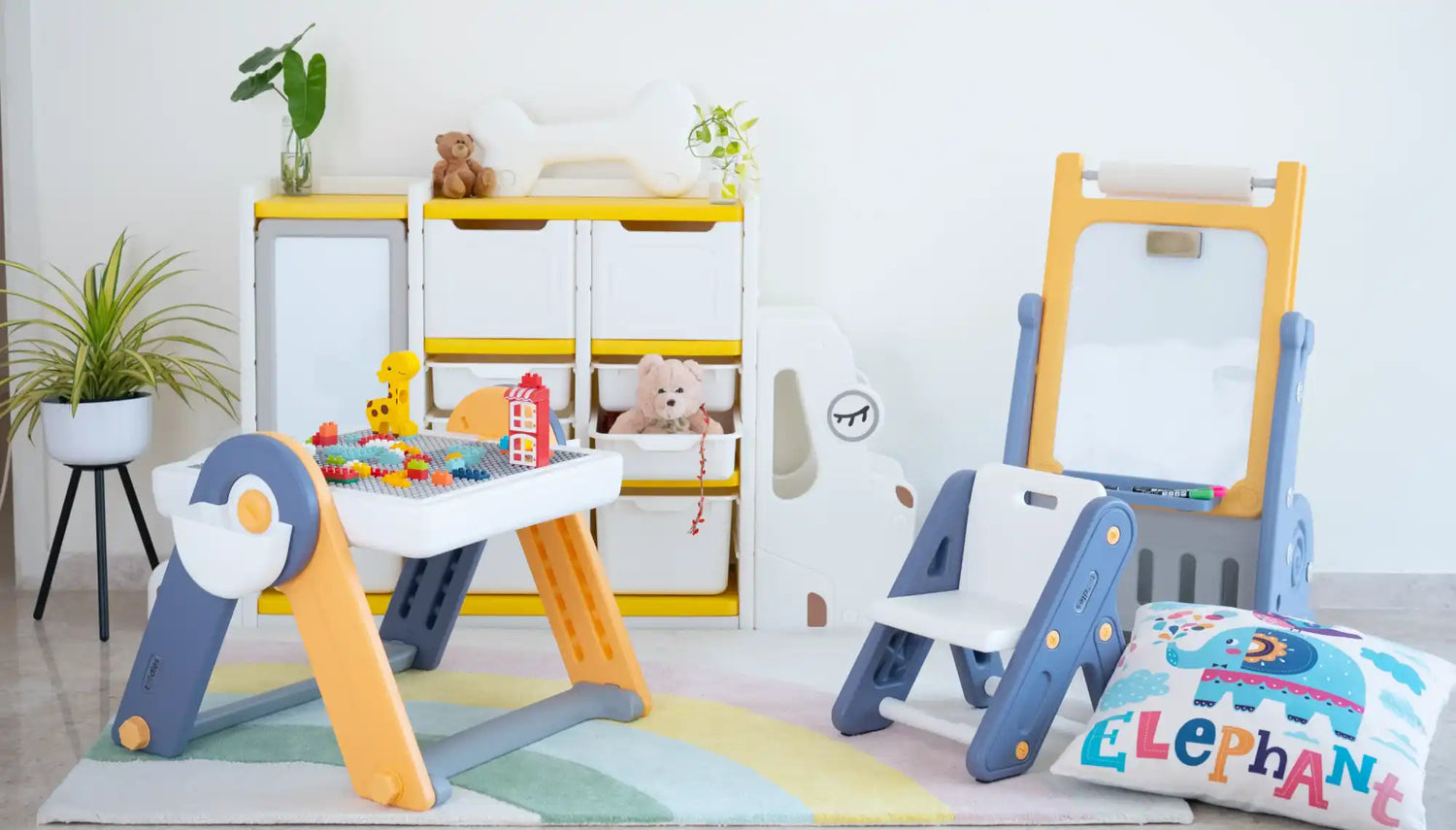 Children’s art station with a yellow and blue easel and storage shelves.