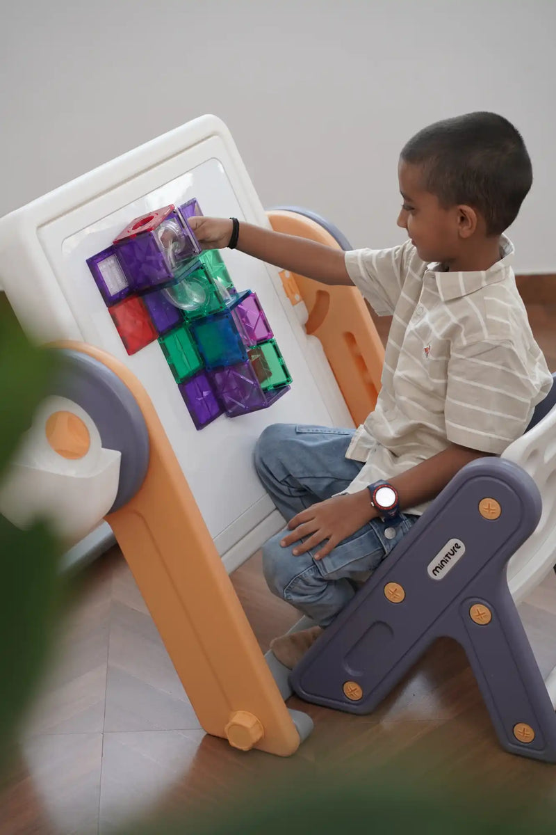 A child’s magnetic building board with various colorful geometric shapes.